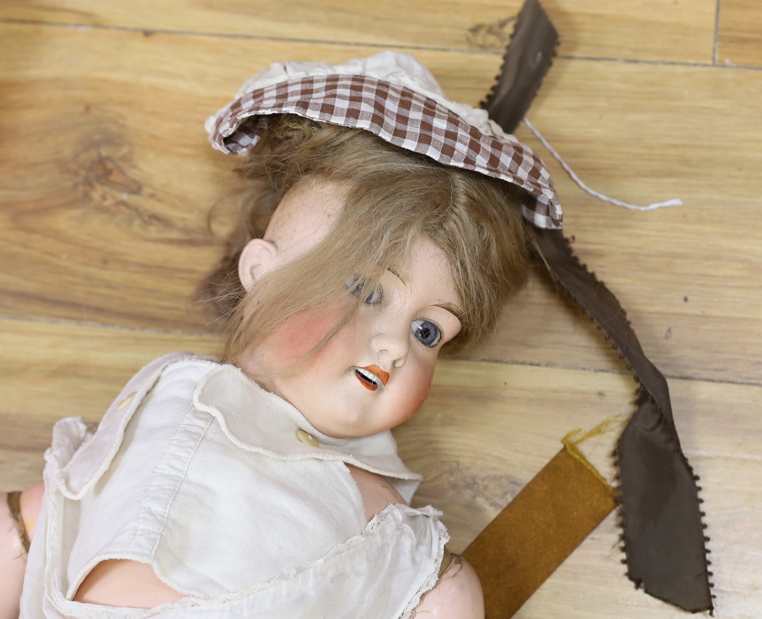An early 20th century Lanternier & Cie, Limoges France bisque head doll, Cherie no. 11 and a another bisque head doll marked 13, limbs incomplete